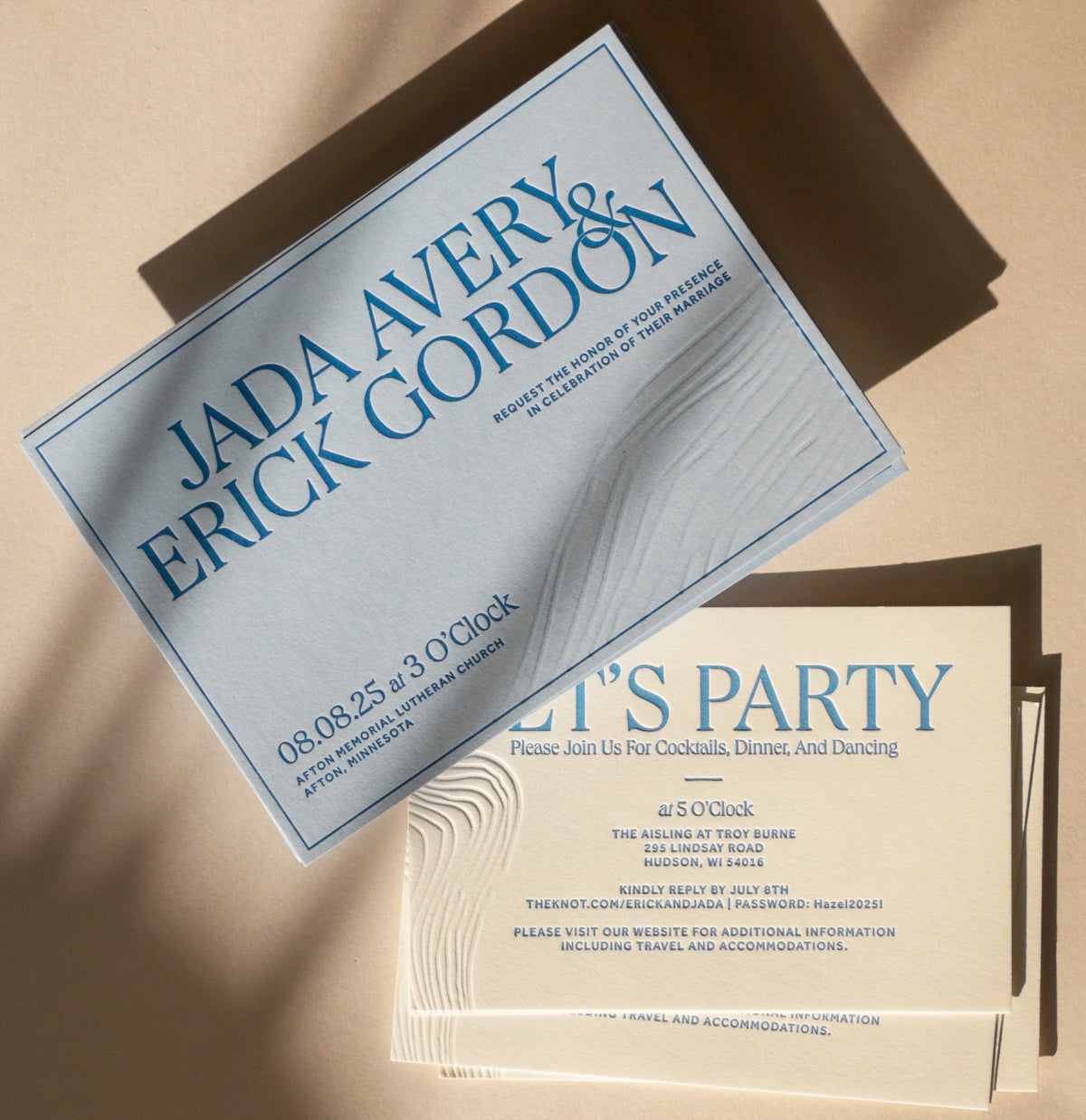 Wedding invitation cards with text on a beige background