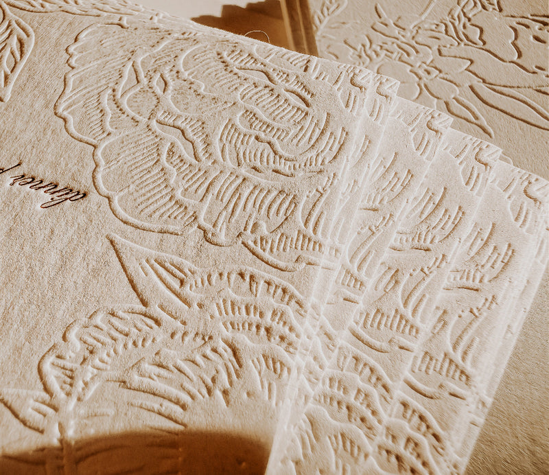 Close-up of textured beige paper with embossed patterns