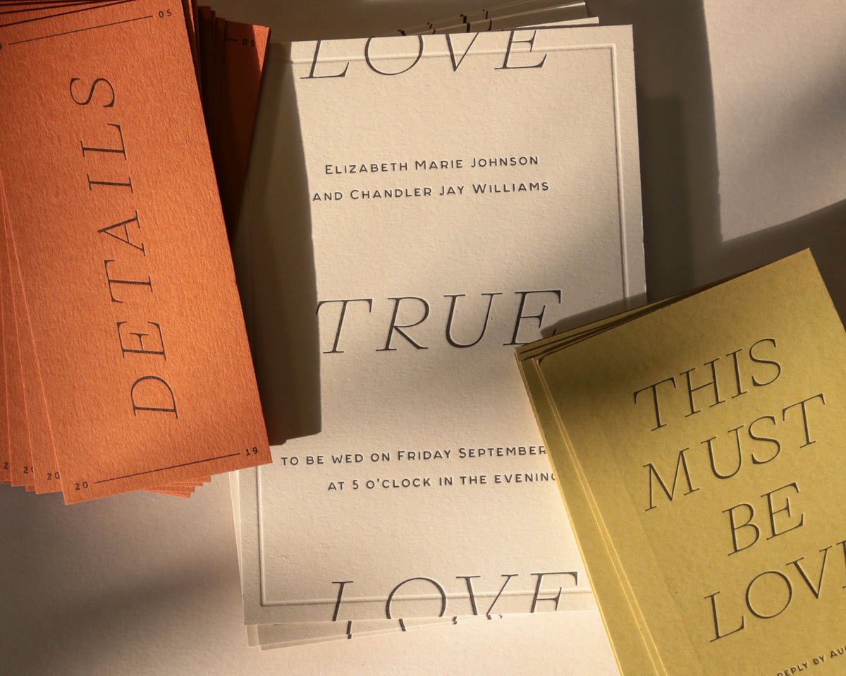 Wedding invitation cards with text on a neutral background