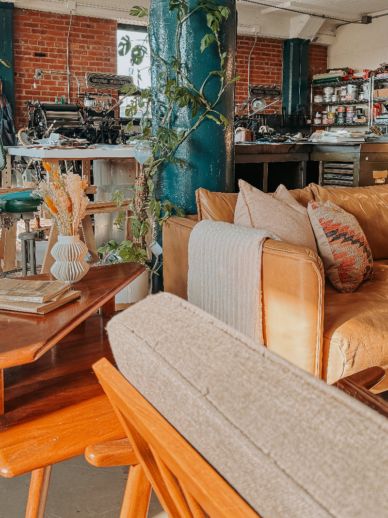 letterpress shop with leather sofa and coffee table